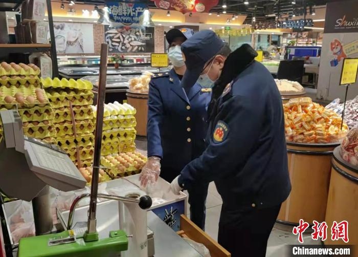 圖為疫情期間，甘肅嘉峪關市場監(jiān)管局工作人員檢查蔬菜市場。　 柴佳楠 　攝